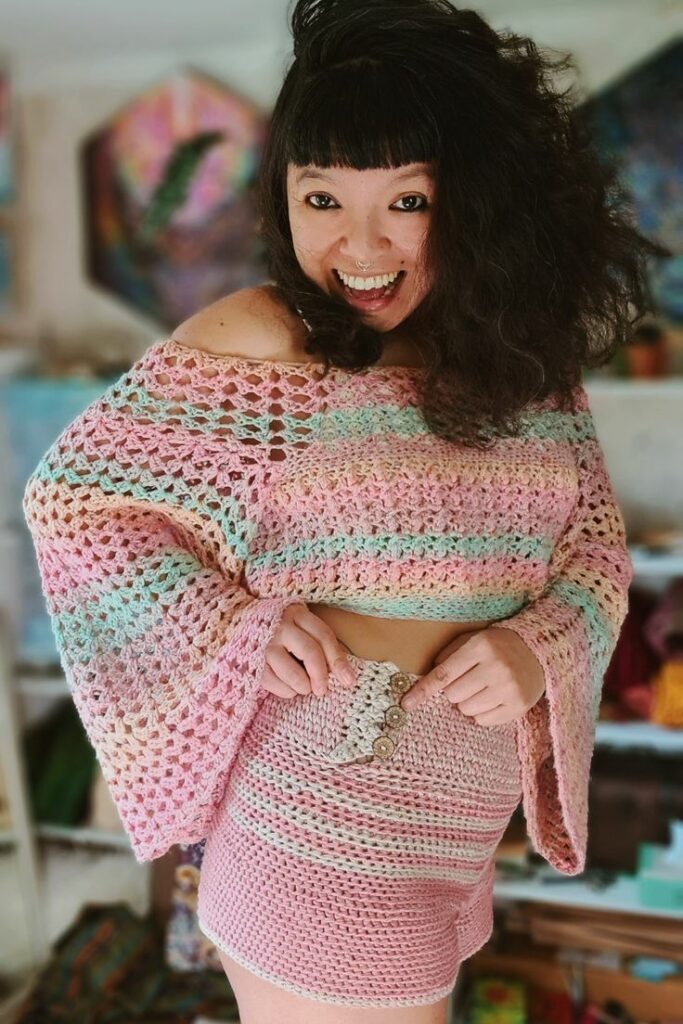 Maya Luna Corazon in stiped crochet bell sleeve she designed