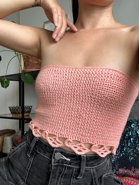 Close-up shot highlighting the unique stitch patterns and design elements of Jordan's halter top, crafted from the free crochet halter top pattern, Halter Hues.