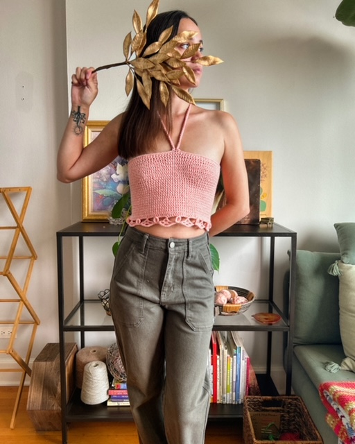 Jordan striking a pose in a full outfit, showcasing her stylish halter top made from the free crochet halter top pattern, Halter Hues.